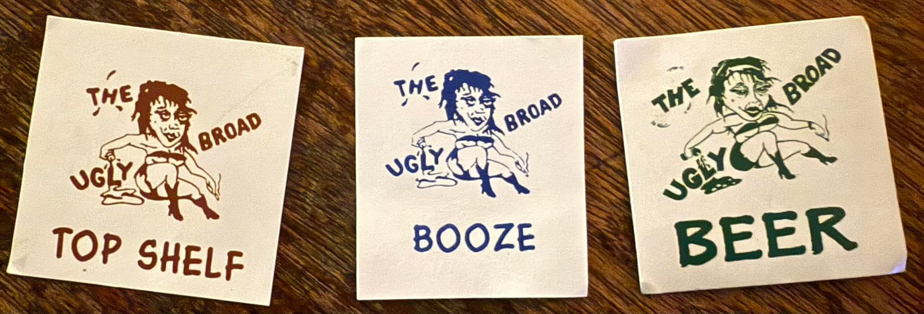 Cards with The Ugly Broad logo on it that say 'Top Shelf', 'Booze', and 'Beer'.
