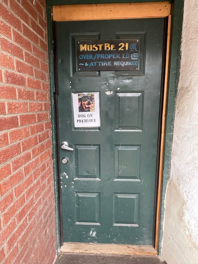 Entrance door to The Ugly Broad with a sign saying 'Dog on premises'