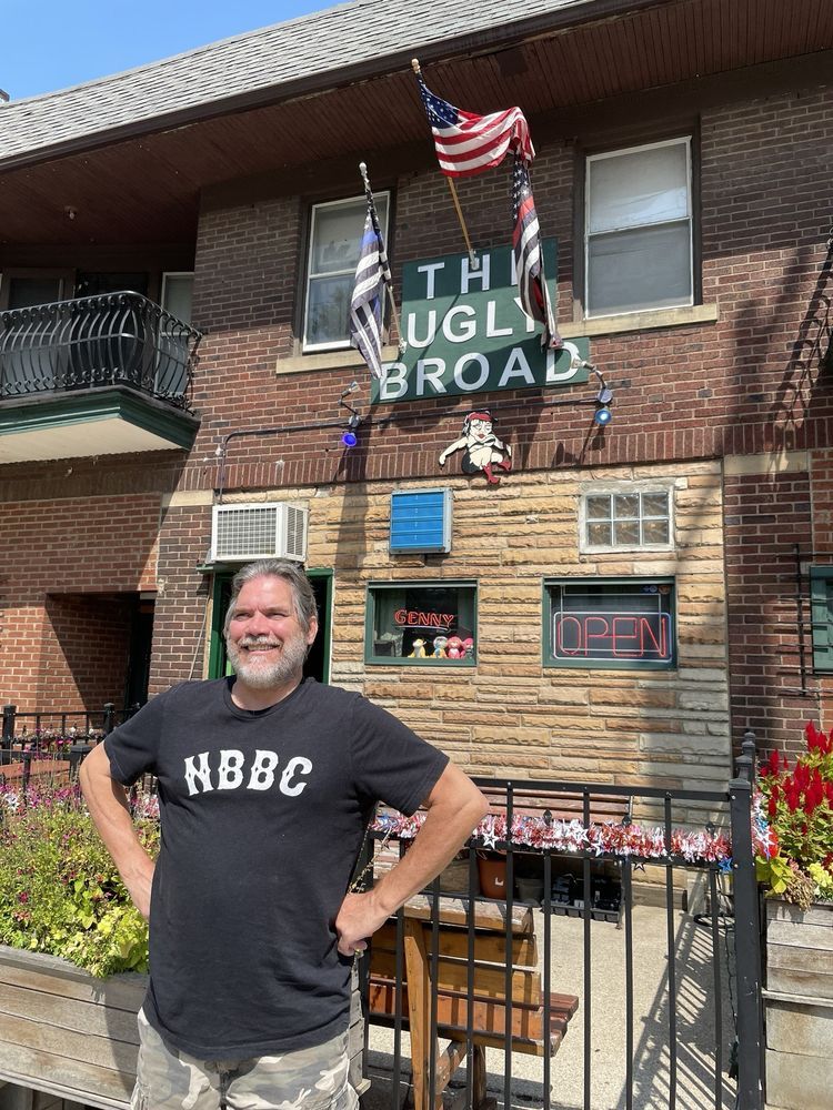 Exterior shot of a man standing in front of The Ugly Broad.