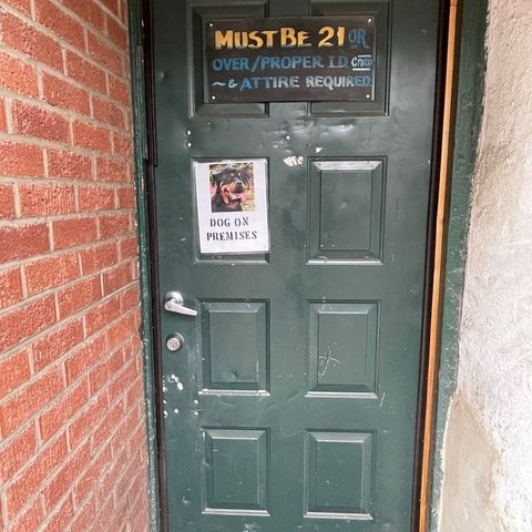 Entrance door to The Ugly Broad with a sign saying 'Dog on premises'