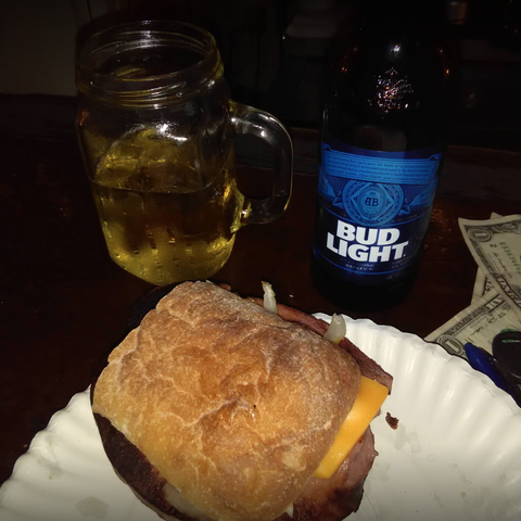 Close-up of sandwich and beer.