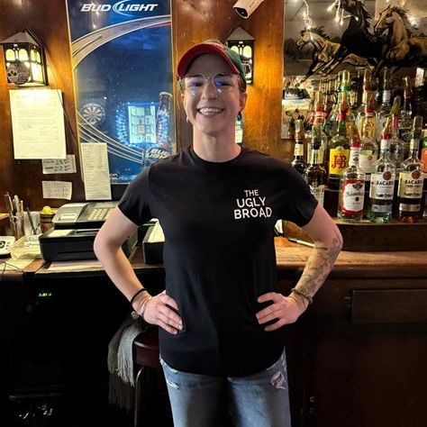 Bartender standing behind the bar.