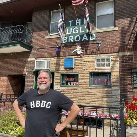 Exterior shot of a man standing in front of The Ugly Broad.